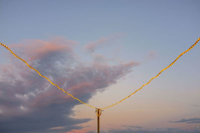 Low angle view of vapor trail against sky during sunset