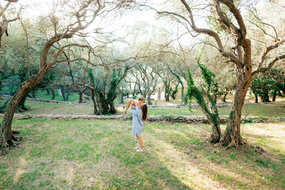 Full length of mother and daughter embracing at park