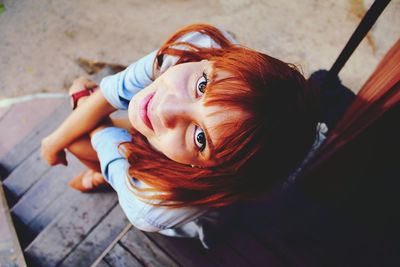 Portrait of smiling girl lying on floor