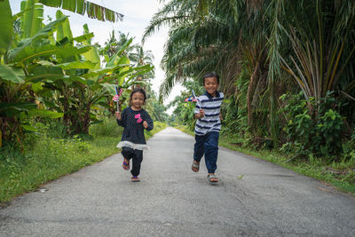 Full length portrait of children on a tree