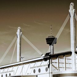 Low angle view of suspension bridge against sky