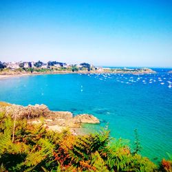 Scenic view of bay against clear blue sky