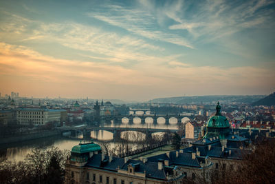 Prague bridges panorama during mist fog morning sunrise warm light red sky