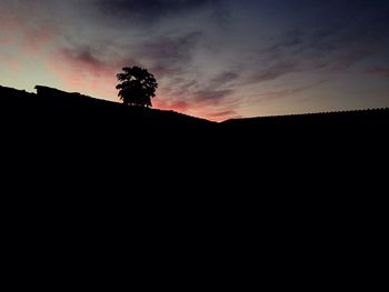 Silhouette landscape against sky at sunset