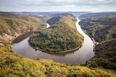 High angle view of lake amidst trees against sky