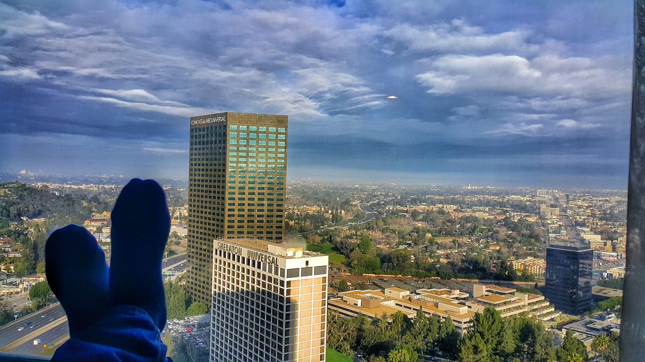 city, building exterior, cityscape, architecture, sky, skyscraper, built structure, cloud - sky, tower, tall - high, men, lifestyles, modern, city life, office building, leisure activity, crowded, cloud