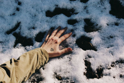 Low section of person on snow covered sand