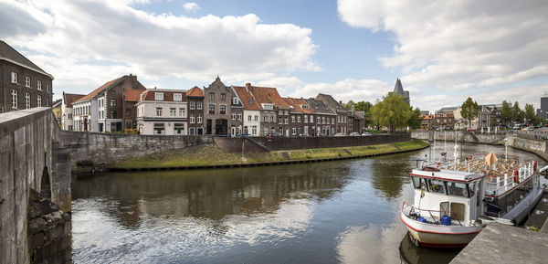 Boats in river with buildings in background