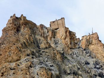 Low angle view of rock formations against sky