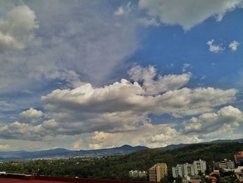 Scenic view of buildings and mountains against sky