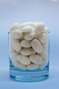 Close-up of stack of eggs against white background