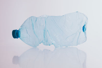 Close-up of plastic bottle against white background