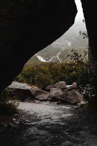 Scenic view of mountains seen through cave