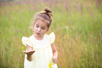 Cute girl standing on field