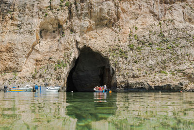 People on rock by river