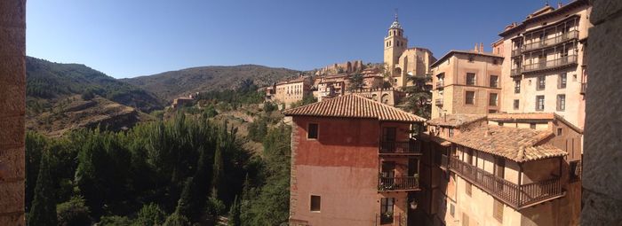 Panoramic view of buildings and mountains against sky