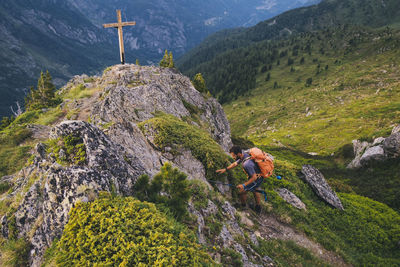Young hiker reaches the summit of aiguillette des posettes, chamonix.