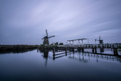 Traditional windmill against sky at dusk
