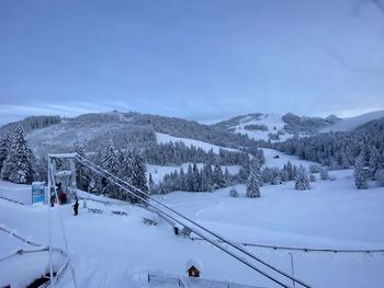 Snow covered land and mountains against sky