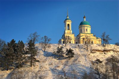 Low angle view of church against blue sky