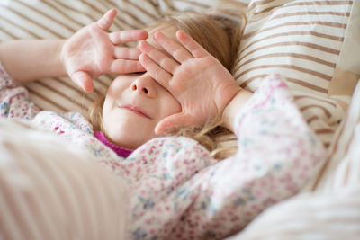 Midsection of woman lying on bed