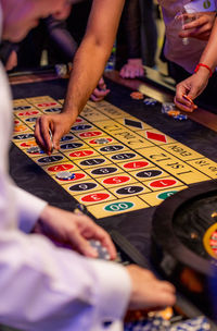 Midsection of woman at a roulette table