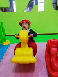 Portrait of cute boy playing with toy