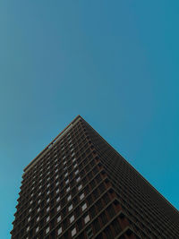 Low angle view of building against clear blue sky