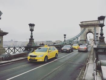 Vehicles on road against sky