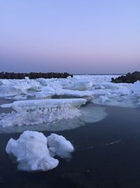 Scenic view of sea against clear sky during sunset