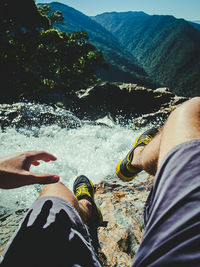 Low section of man standing on mountain