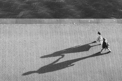 High angle view of people walking by swimming pool