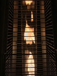 Low angle view of illuminated lamp at night