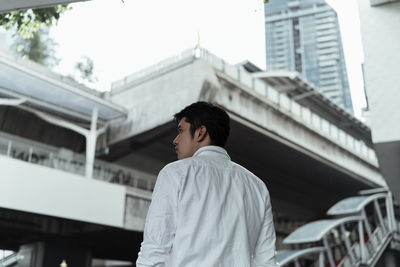 Low angle view of businessman standing in city