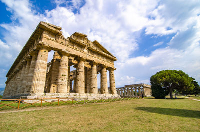 Low angle view of historical building against clear blue sky  , temple of paestum. italy