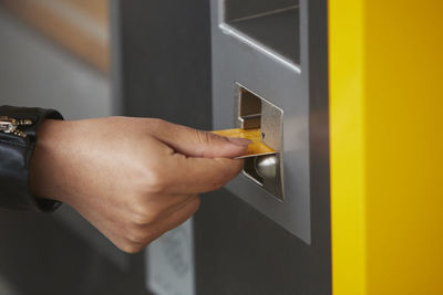 Hand using ticket machine