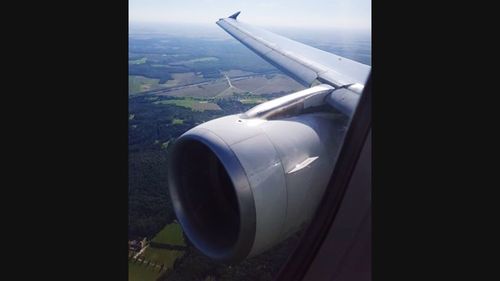 Airplane wing over landscape