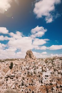 Aerial view of townscape against cloudy sky