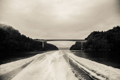 A dramatic, overcast scenery on the coast of fjord during a ferry ride in norway near bergen. 