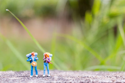 Male and female figurines on footpath