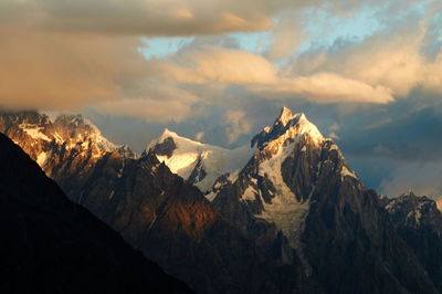 Scenic view of mountains against cloudy sky