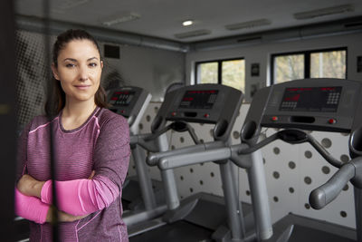 Portrait of woman with arms crossed standing in gym