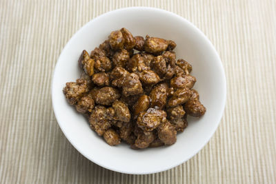 Directly above shot of roasted almonds in bowl on table