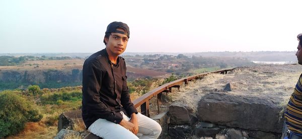 Portrait of young man against mountain