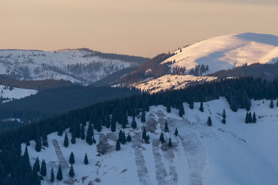 Panoramic view of snow covered land and mountains against sky