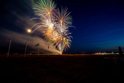 Low angle view of firework display at night