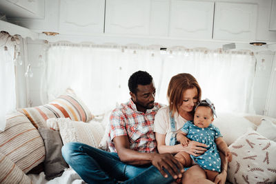 Cheerful family siting in camper van