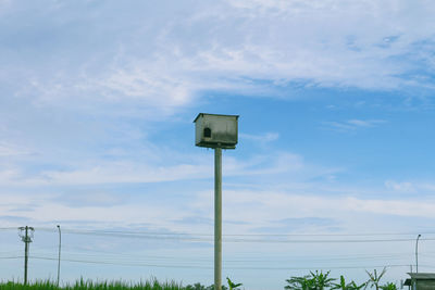 Low angle view of road sign against sky