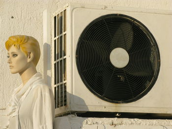 Close-up of female sculpture against wall