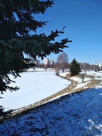 Scenic view of frozen lake against clear blue sky